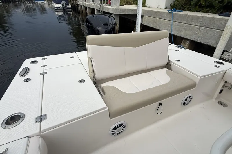 Slide: The Image of 2016 Robalo 246 Cayman boat interior with cushioned seating and storage compartments. - 9