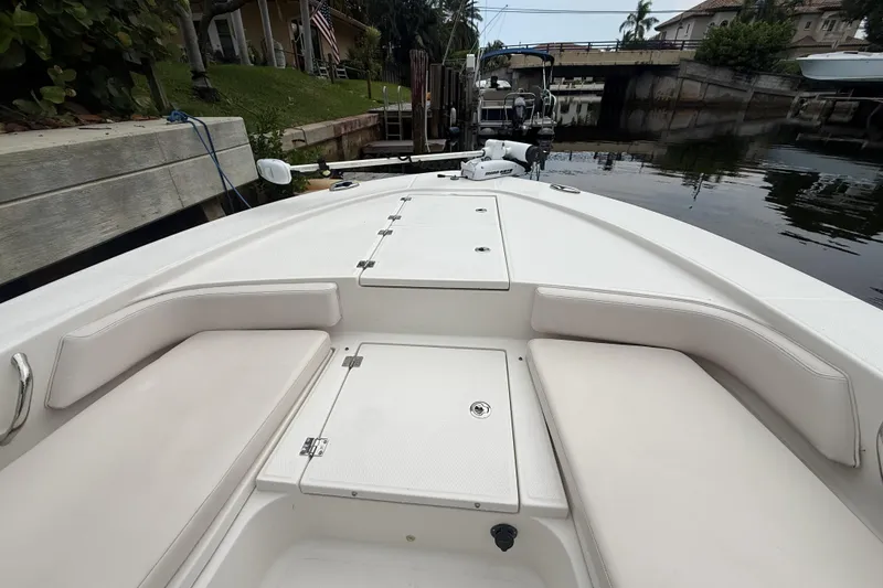 Slide: The Image of 2016 Robalo 246 Cayman boat interior with seating and storage compartments. - 6