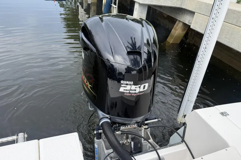 Slide: The Image of Yamaha 250 outboard engine on a 2016 Robalo 246 Cayman boat by the dock. - 5