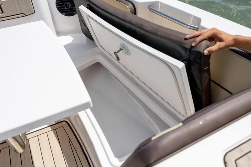 Slide: The Image of 2023 Yamaha Boats 222 FSH Sport E storage compartment with cushioned seating. - 17