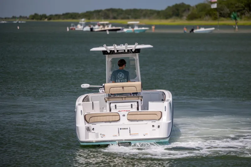 Slide: The Image of 2023 Yamaha Boats 222 FSH Sport E cruising on a scenic waterway. - 5
