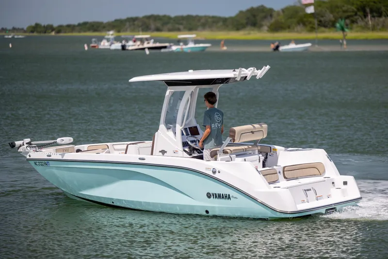 Slide: The Image of 2023 Yamaha Boats 222 FSH Sport E cruising on a serene lake. - 3