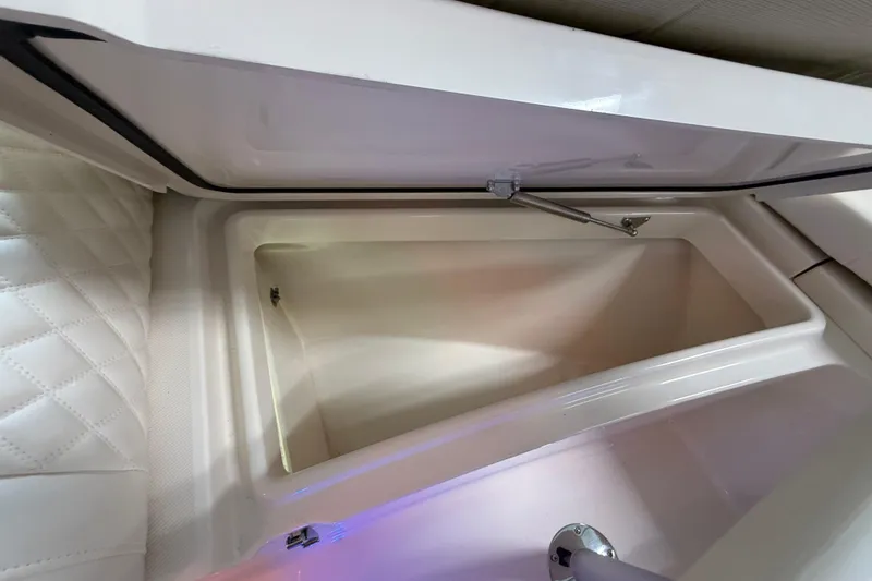 Slide: The Image of Open storage compartment in 2026 Grady-White Freedom 235 boat, featuring quilted upholstery. - 25