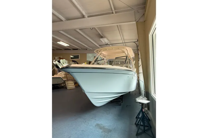 Slide: The Image of 2026 Grady-White Freedom 235 boat displayed indoors, showcasing sleek design and craftsmanship. - 3