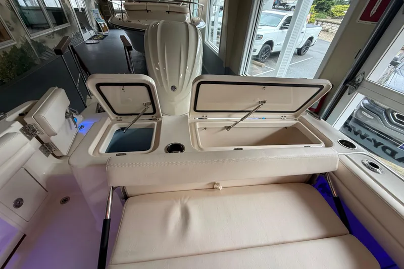 Slide: The Image of 2026 Grady-White Freedom 235 boat interior with open storage compartments and seating. - 33