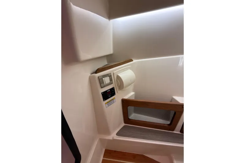 Slide: The Image of Interior of 2026 Grady-White Freedom 235 boat, featuring control panel and storage area. - 28