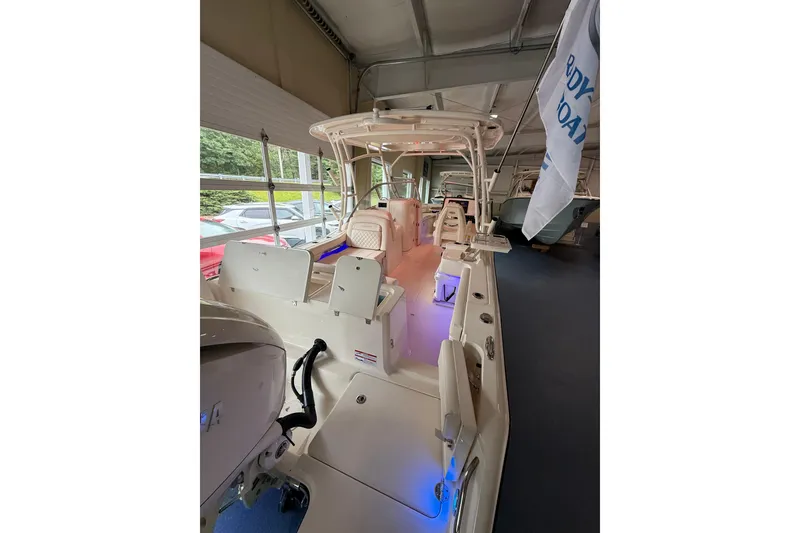 Slide: The Image of 2026 Grady-White Freedom 235 boat interior with seating and modern features in showroom. - 39