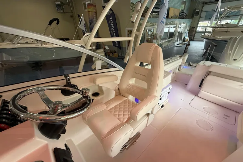 Slide: The Image of Interior of 2026 Grady-White Freedom 235 boat, featuring luxurious seating and modern steering wheel. - 15