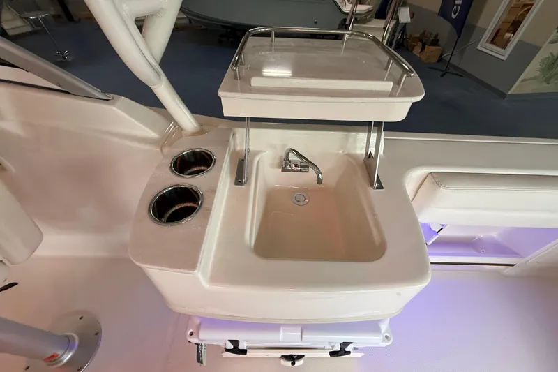 Slide: The Image of Grady-White Freedom 235 boat sink area with cup holders, 2026 model. - 19