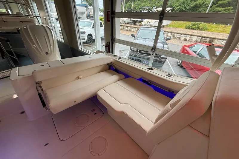 Slide: The Image of 2026 Grady-White Freedom 235 boat interior with plush seating and modern design. - 22