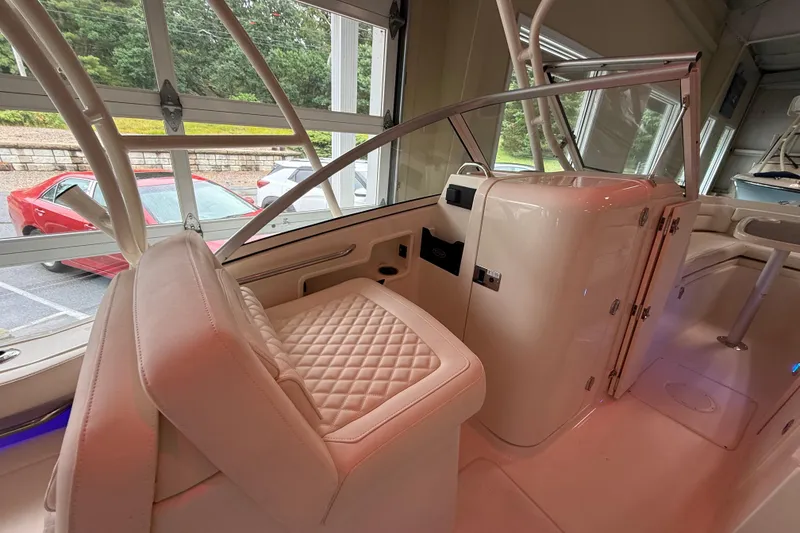 Slide: The Image of 2026 Grady-White Freedom 235 boat interior with luxurious seating and modern design. - 10
