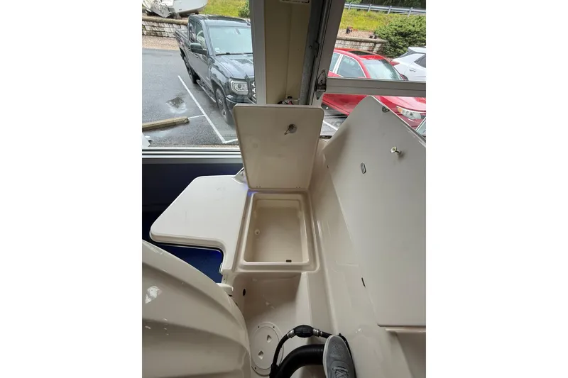 Slide: The Image of 2026 Grady-White Freedom 235 boat interior with open storage compartment. - 34
