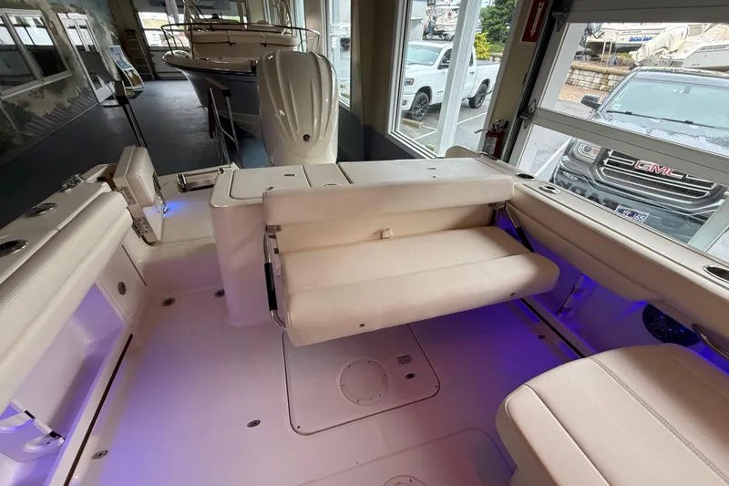 Slide: The Image of 2026 Grady-White Freedom 235 boat interior with seating and ambient lighting. - 21