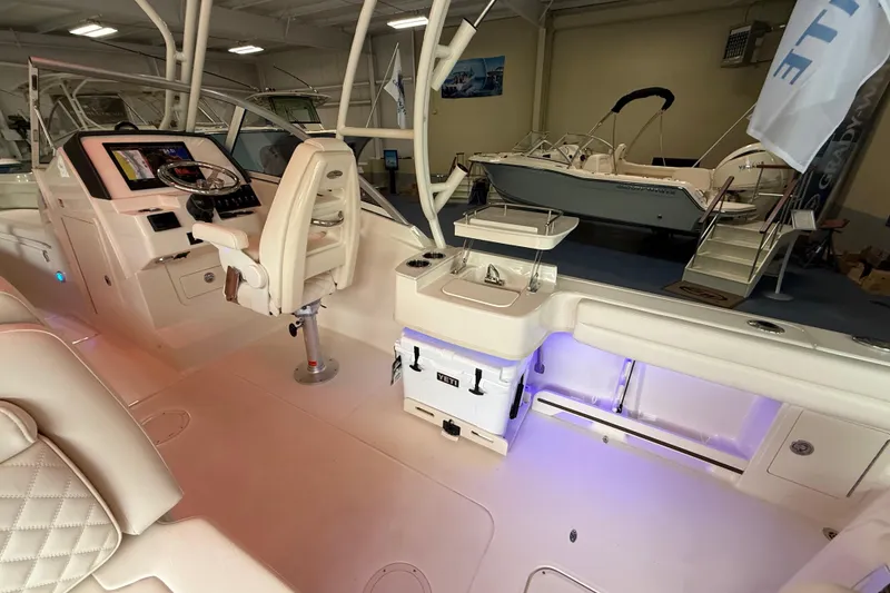 Slide: The Image of 2026 Grady-White Freedom 235 boat interior with modern helm and seating. - 9