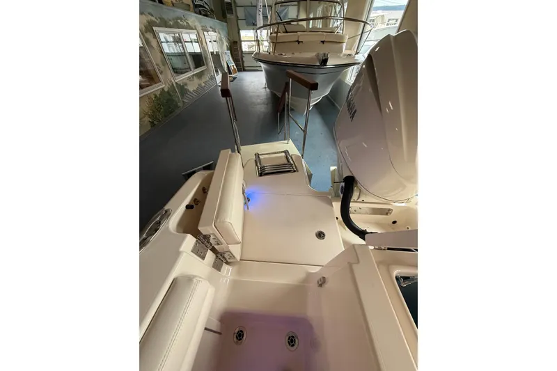 Slide: The Image of 2026 Grady-White Freedom 235 boat interior with Yamaha engine in showroom. - 35
