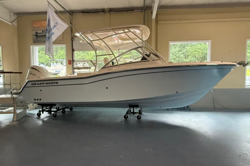 The Image of 2026 Grady-White Freedom 235 boat displayed indoors, showcasing sleek design and modern features. - 1