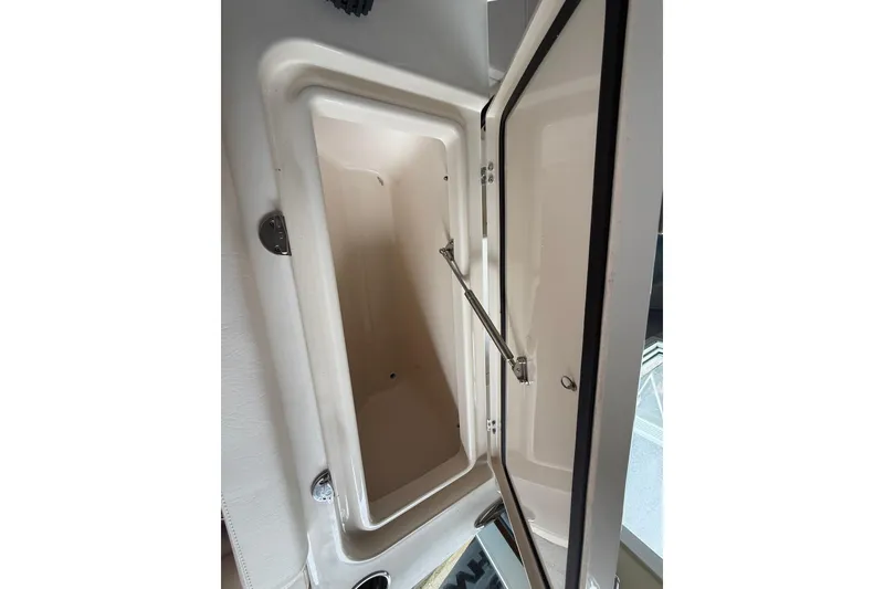 Slide: The Image of Open storage compartment on 2026 Grady-White Freedom 235 boat. - 32