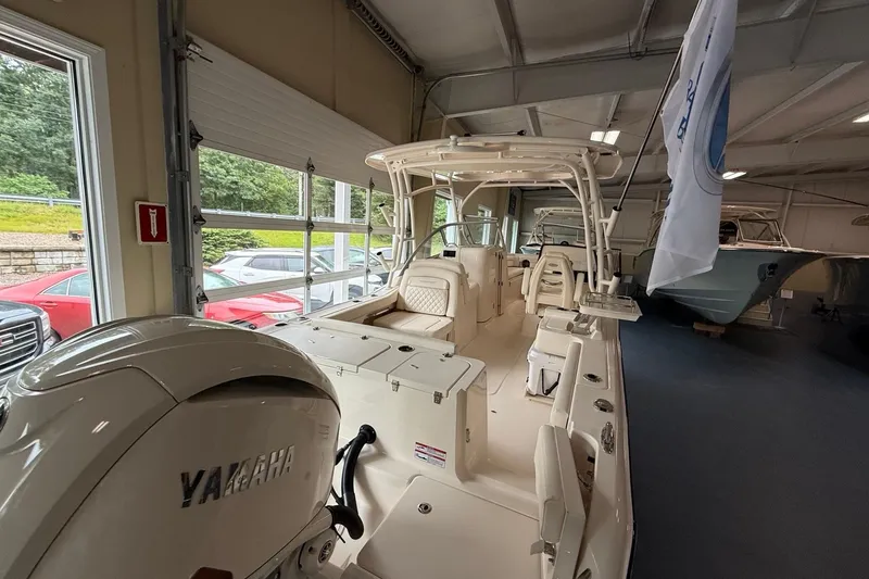 Slide: The Image of 2026 Grady-White Freedom 235 boat displayed indoors with Yamaha engine. - 5