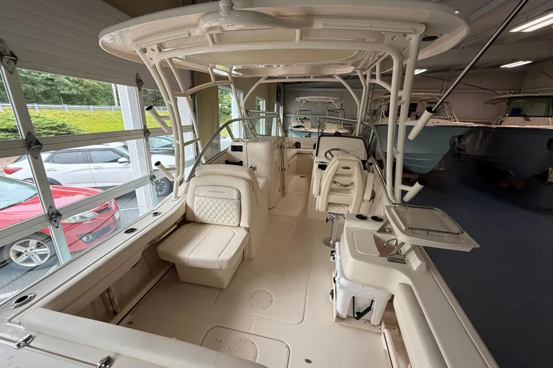 Slide: The Image of 2026 Grady-White Freedom 235 boat interior with seating and helm in showroom. - 6