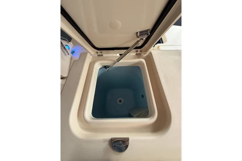 Slide: The Image of Livewell compartment on 2026 Grady-White Freedom 235 boat, open lid view. - 31