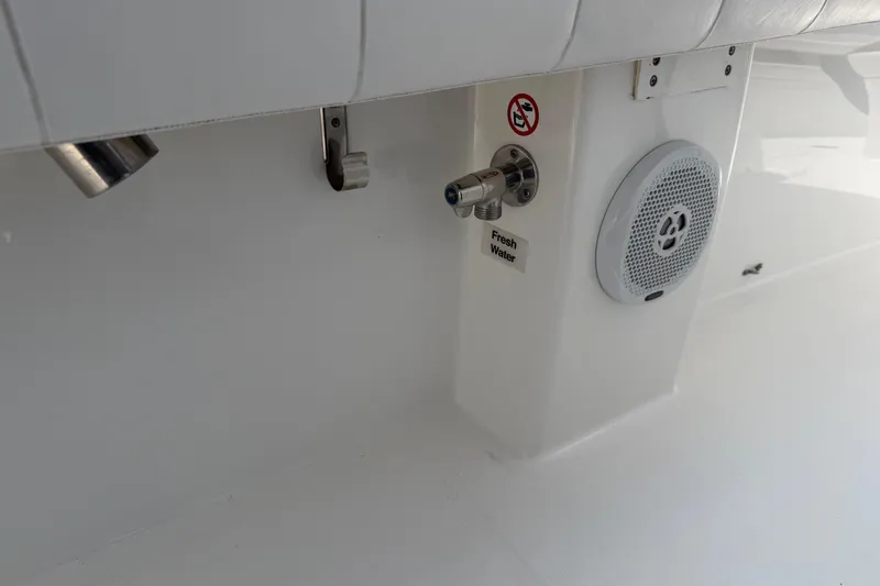 Slide: The Image of 2015 Regulator 23 Center Console boat interior with fresh water outlet and speaker. - 6
