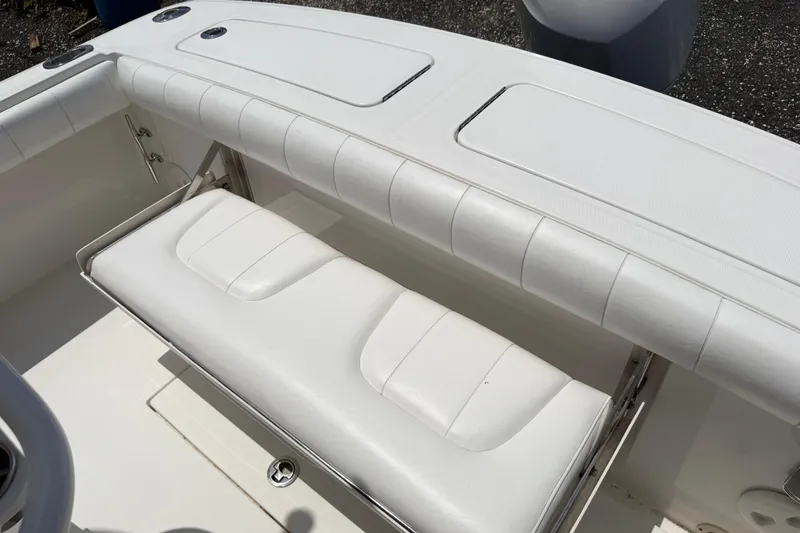 Slide: The Image of 2015 Regulator 23 Center Console boat with white cushioned seating. - 12