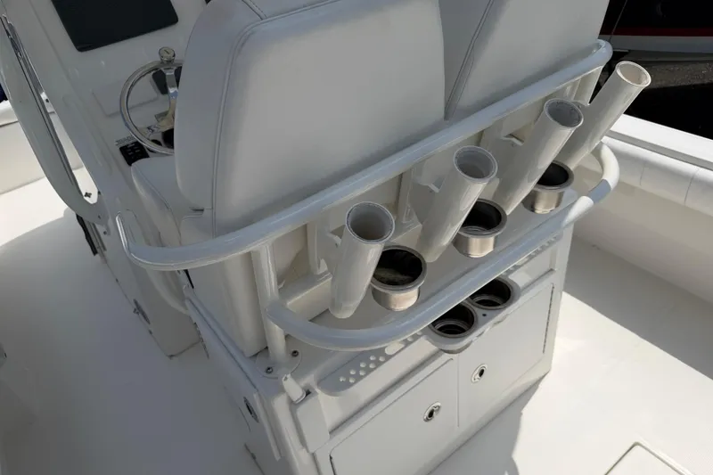 Slide: The Image of 2015 Regulator 23 Center Console boat interior with rod holders and storage compartments. - 14