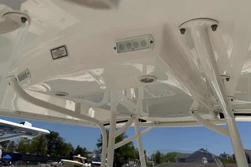 Slide: The Image of 2015 Regulator 23 Center Console boat's T-top structure with integrated lighting. - 22