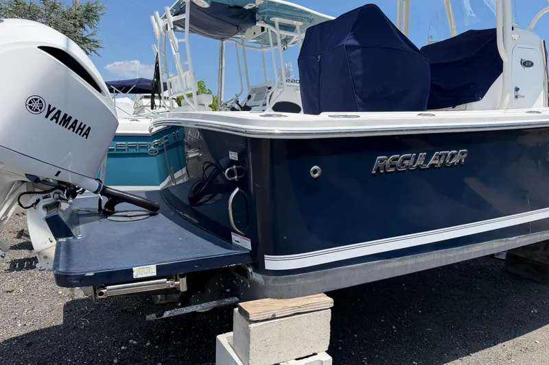 Slide: The Image of 2015 Regulator 23 Center Console boat with Yamaha engine, docked on blocks. - 5