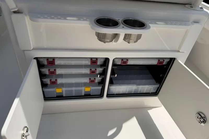 Slide: The Image of 2015 Regulator 23 Center Console storage compartments with tackle boxes and cup holders. - 11