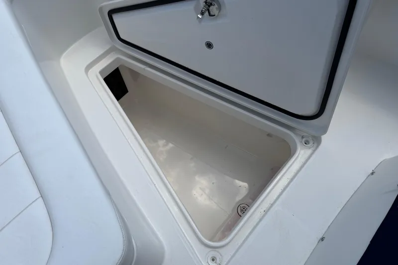 Slide: The Image of Storage compartment on a 2015 Regulator 23 Center Console boat, open and empty. - 29