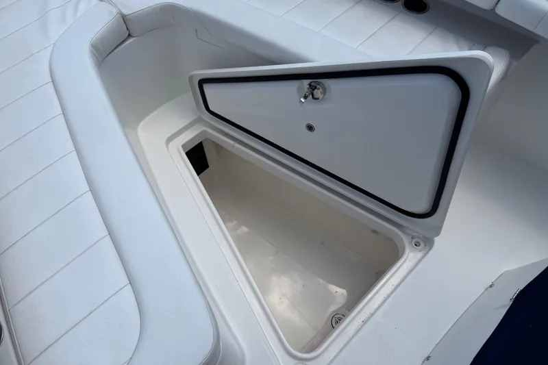 Slide: The Image of Open storage compartment on a 2015 Regulator 23 Center Console boat. - 34