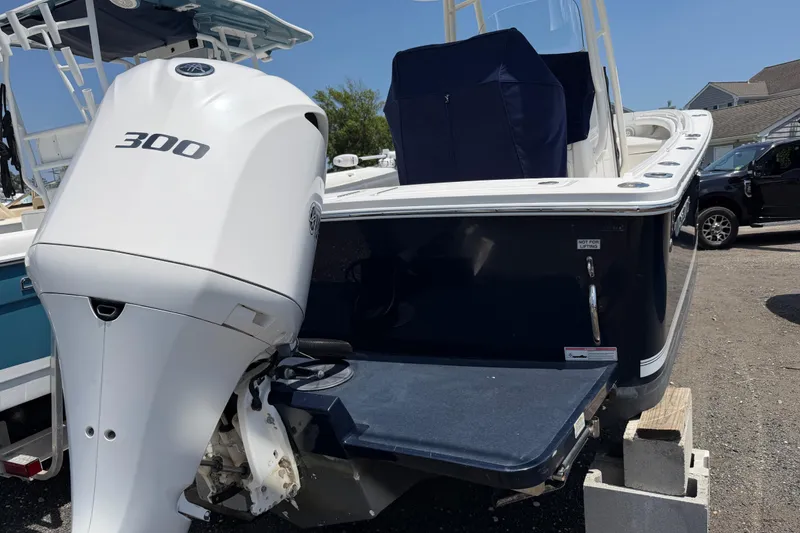 Slide: The Image of 2015 Regulator 23 Center Console boat with 300 horsepower engine, docked outdoors. - 3
