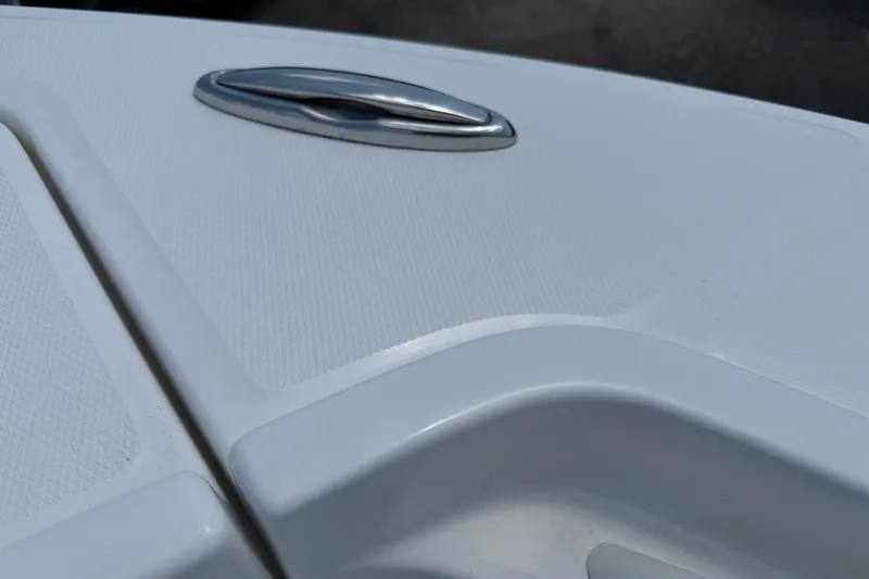 Slide: The Image of Close-up of a 2015 Regulator 23 Center Console boat's textured deck and chrome handle. - 30