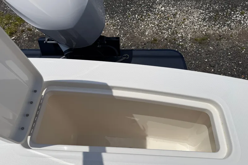 Slide: The Image of Open storage compartment on a 2015 Regulator 23 Center Console boat. - 8