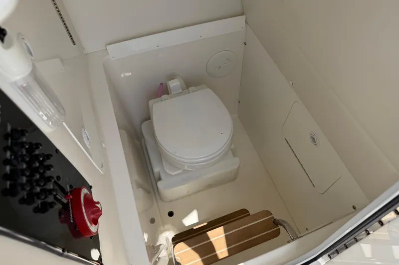 Slide: The Image of 2015 Regulator 23 Center Console boat interior with compact marine toilet. - 26