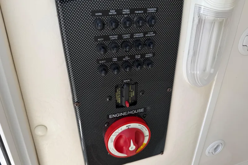 Slide: The Image of Control panel of a 2015 Regulator 23 Center Console boat with switches and dials. - 13