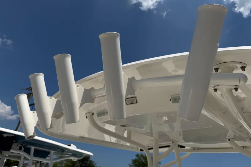 Slide: The Image of Rod holders on a 2015 Regulator 23 Center Console boat under a clear blue sky. - 24