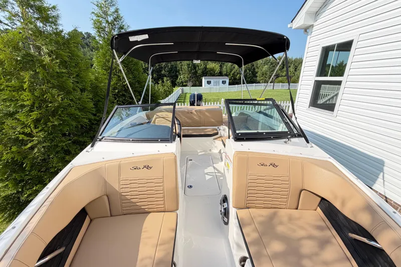 Slide: The Image of 2024 Sea Ray SPX 190 Outboard boat with tan seating and black canopy. - 8