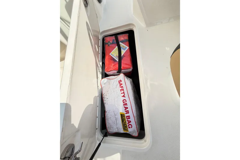Slide: The Image of 2024 Sea Ray SPX 190 Outboard storage compartment with safety gear bag. - 31