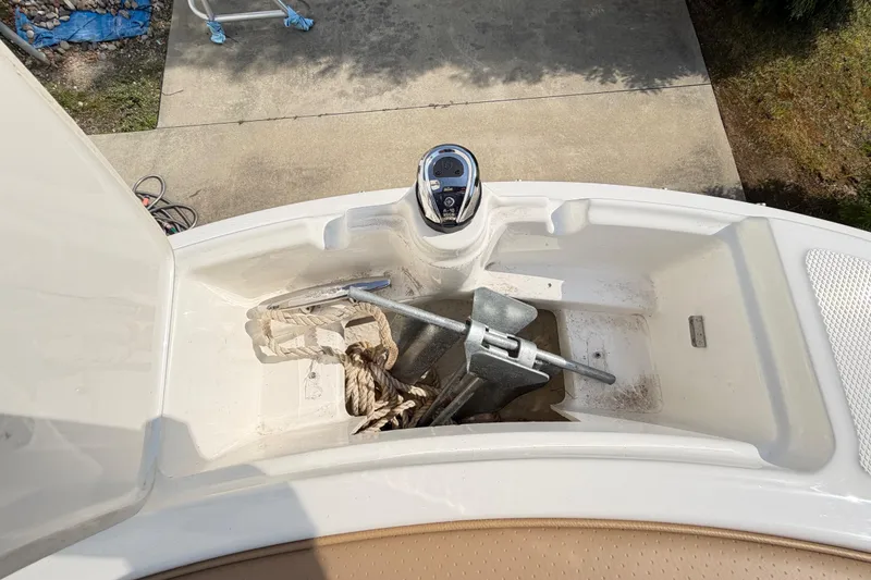 Slide: The Image of 2024 Sea Ray SPX 190 Outboard anchor compartment with rope and anchor visible. - 39
