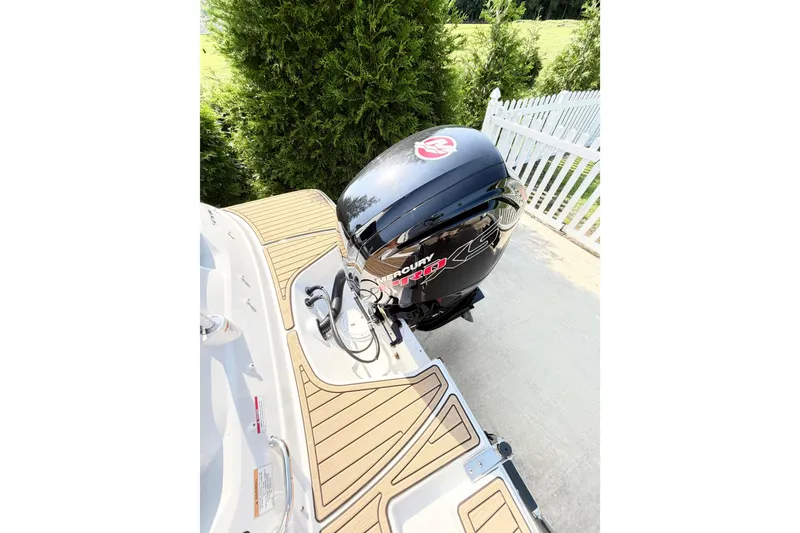 Slide: The Image of 2024 Sea Ray SPX 190 Outboard with Mercury engine, docked near white fence. - 41