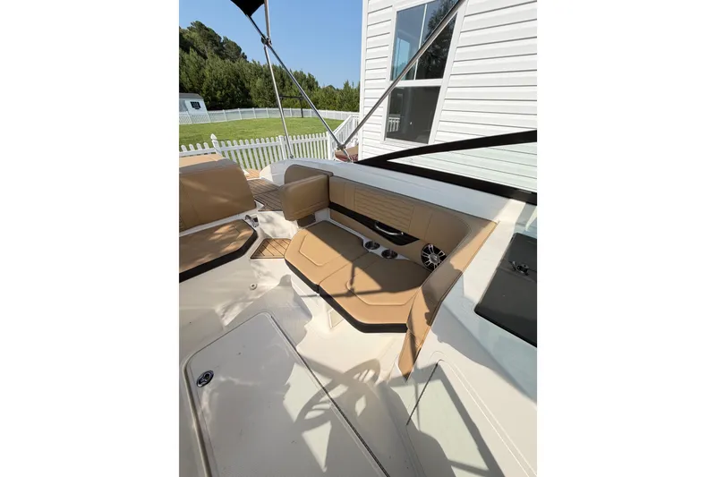 Slide: The Image of 2024 Sea Ray SPX 190 Outboard interior with tan seating and modern design. - 17