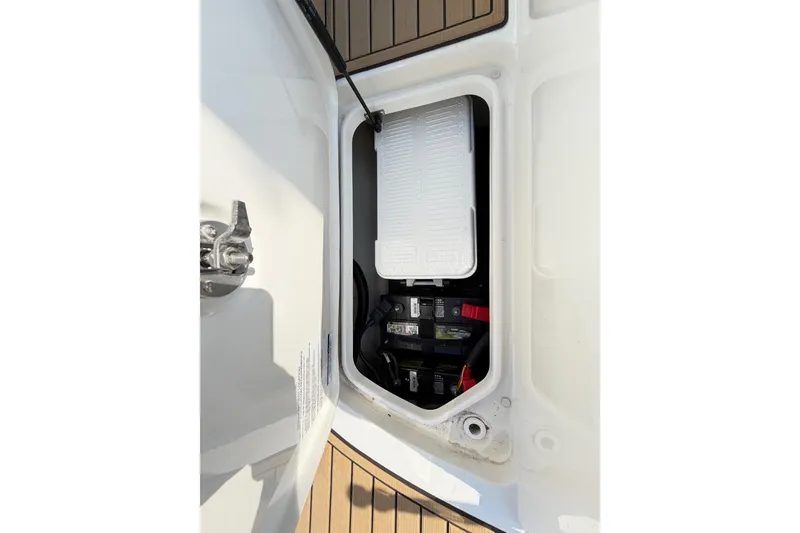 Slide: The Image of 2024 Sea Ray SPX 190 Outboard battery compartment with secure storage and wiring. - 34
