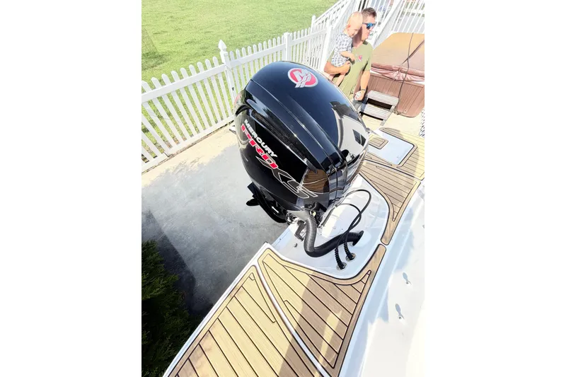 Slide: The Image of 2024 Sea Ray SPX 190 Outboard with Mercury engine, docked near white fence. - 42