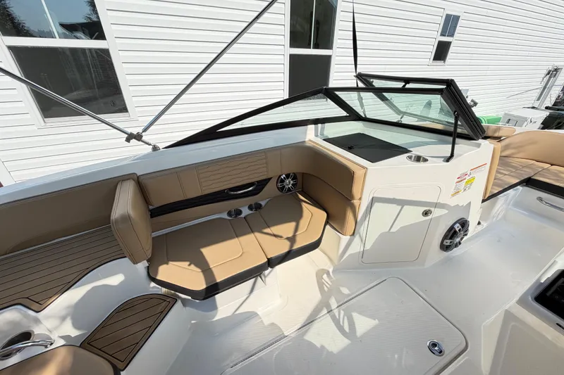 Slide: The Image of 2024 Sea Ray SPX 190 Outboard boat interior with tan seating and modern design. - 10