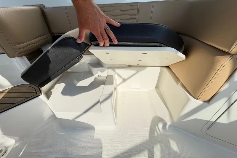 Slide: The Image of 2024 Sea Ray SPX 190 Outboard boat seat storage compartment being accessed. - 35