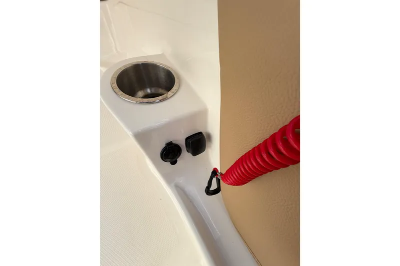 Slide: The Image of 2024 Sea Ray SPX 190 Outboard interior detail with cup holder and red safety cord. - 38