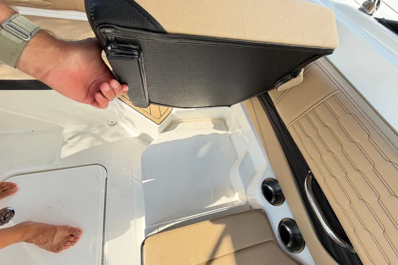 Slide: The Image of 2024 Sea Ray SPX 190 Outboard interior with tan seating and storage compartment. - 36