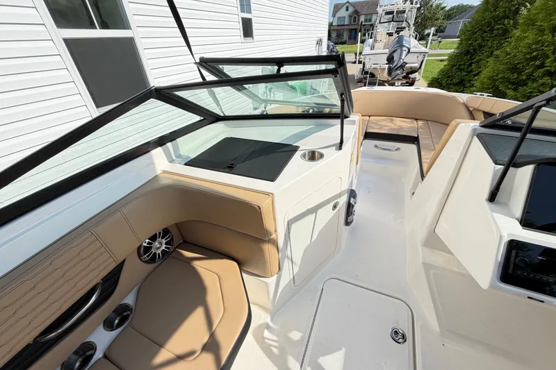 Slide: The Image of 2024 Sea Ray SPX 190 Outboard boat interior with tan seating and sleek design. - 15